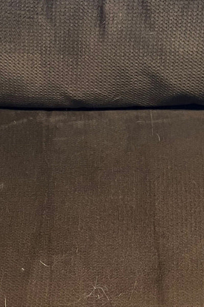 A brown couch cushion that's completely clean, no hair in sight.